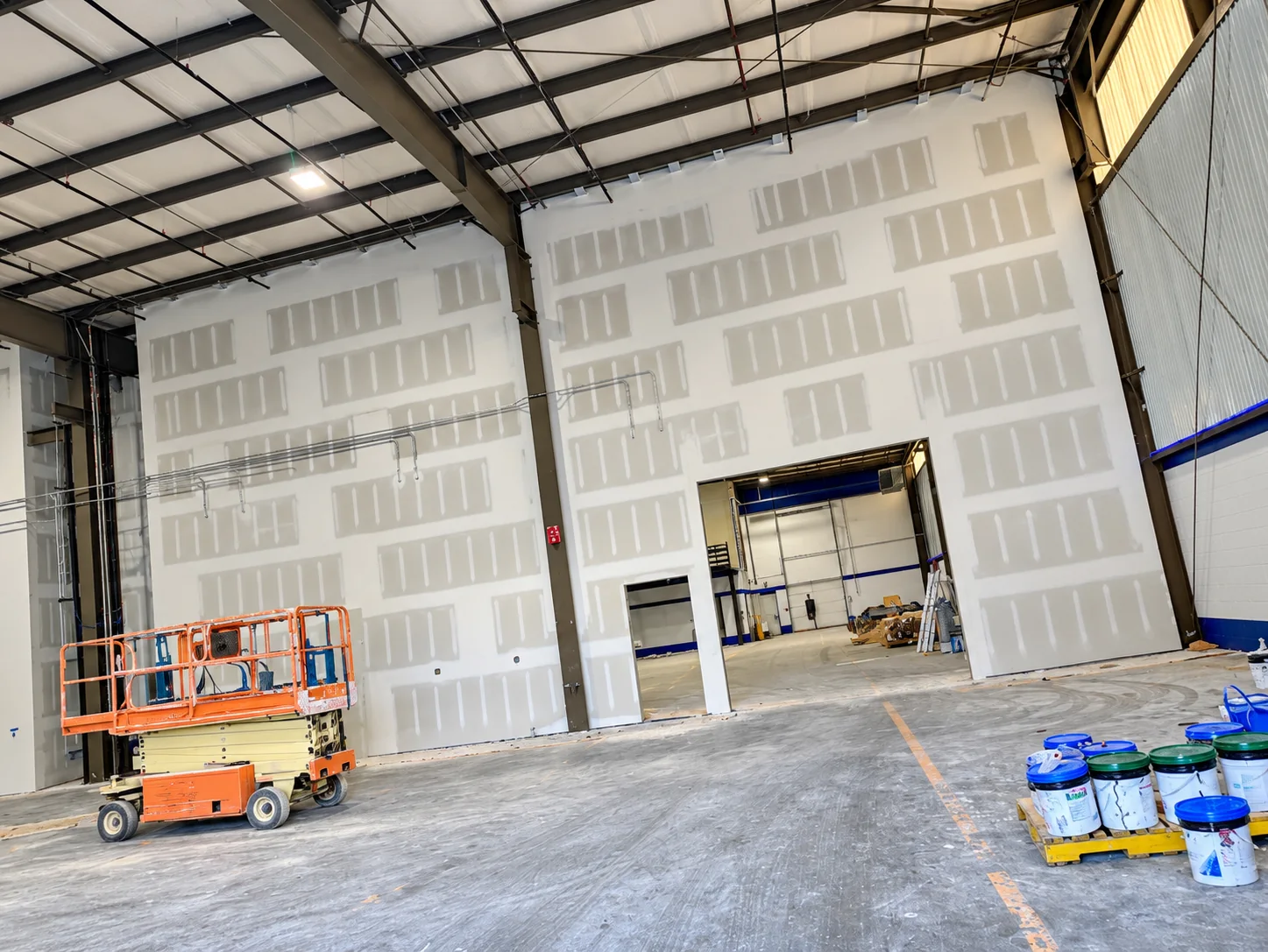 Tall commercial drywall partitions during finishing